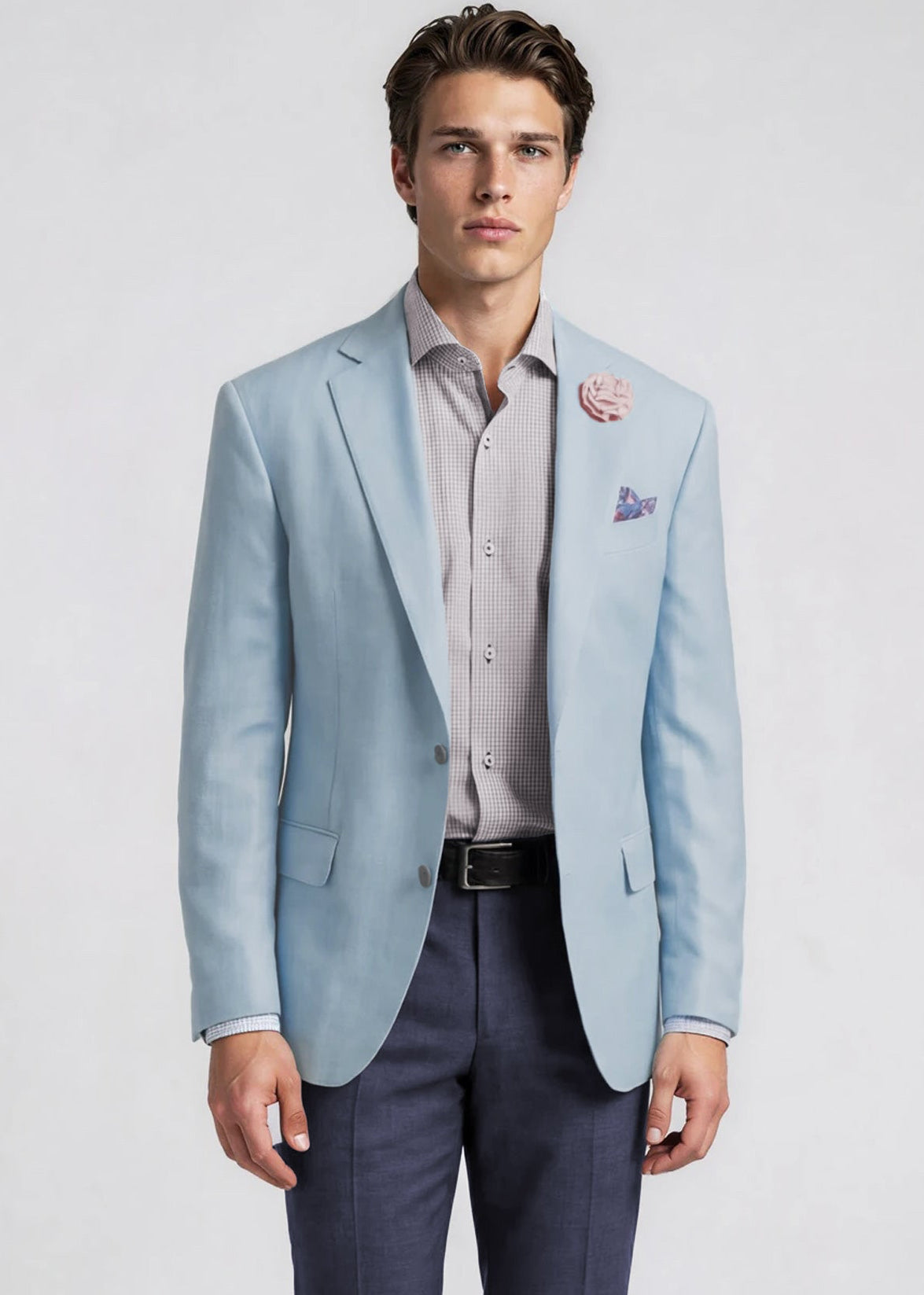 Man wearing a light blue blazer over a striped shirt with a white background