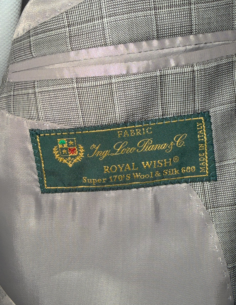 Fabric label on a gray brown checkered fabric with 'Royal Wish' Loro Piana  branding.