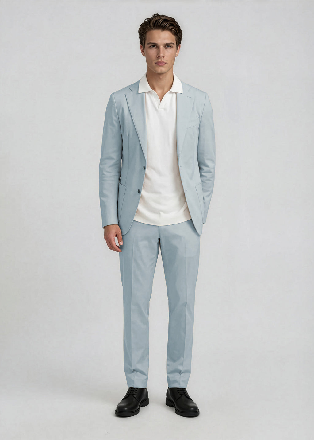 Man wearing a light gray suit with a white shirt on a plain background