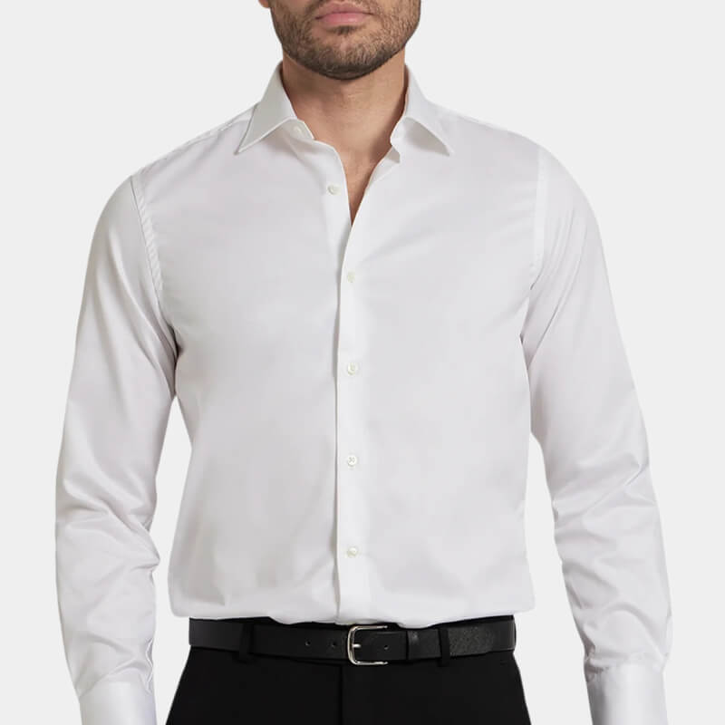 Model wearing crisp white Ike Behar dress shirt against pale gray background 