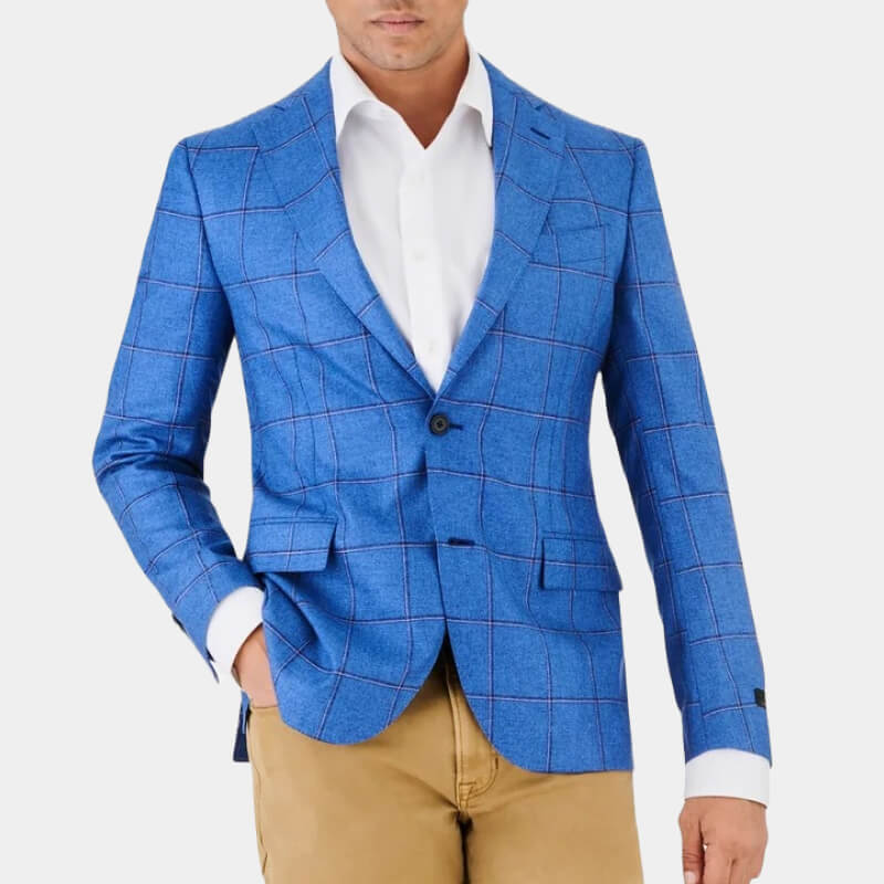 Model wearing bright blue Ike Behar sport coat against pale gray background 