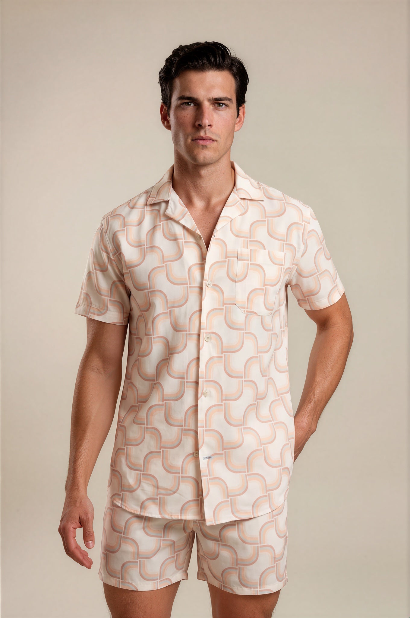 Man wearing a matching shirt and shorts set with a geometric pattern on a beige background