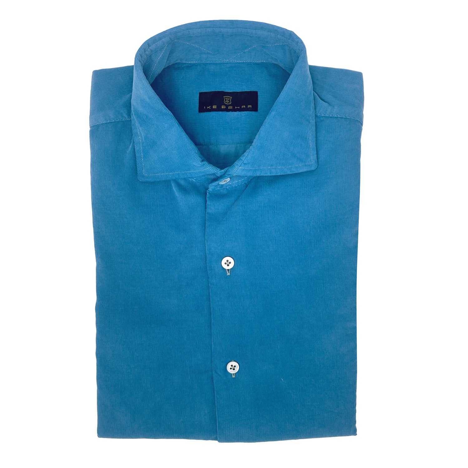 Folded aqua corduroy shirt with a ike behar brand label on a white background